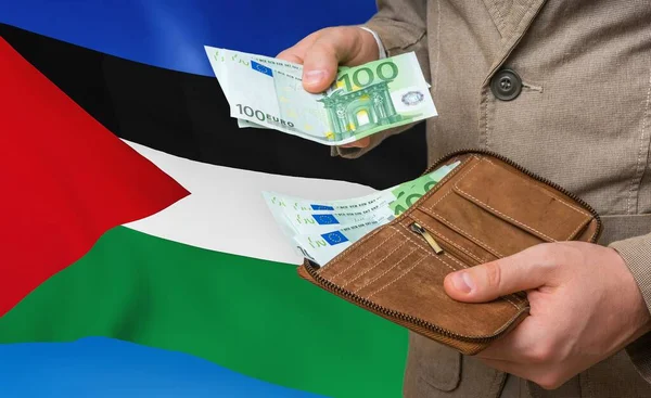 Investing money to Palestine. Rich man with a lot of money.