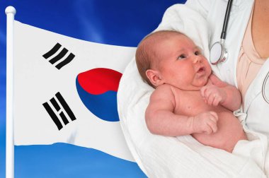 Birth rate in South Korea. Newborn baby in hands of doctor. clipart