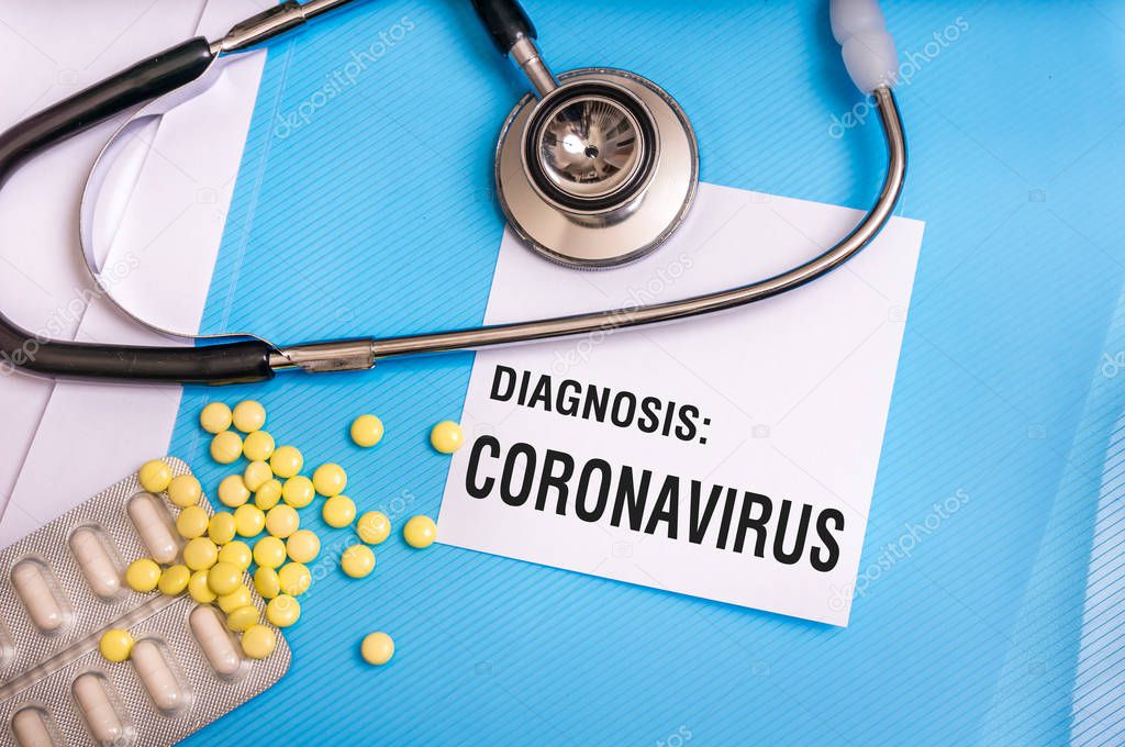 Coronavirus word written on medical blue folder with patient fil