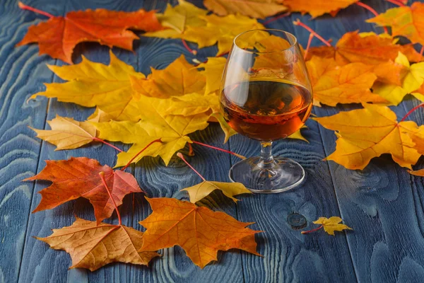 Alcool assaisonné. Snifter verre avec de l'eau de vie de couleur ambre sur un — Photo