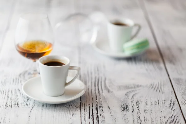 Two cups of coffee on restaurant terrace with afternoon sunlight