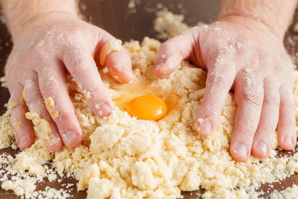 Making dough by male hands at bakery