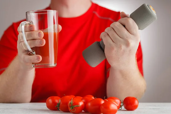 Tomato juice in hand — Stock Photo, Image