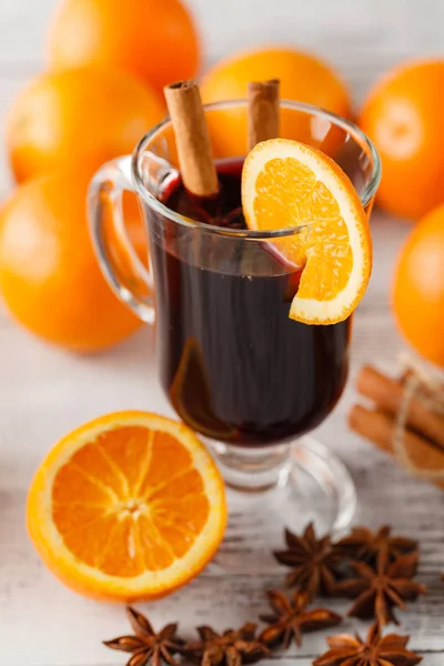 Mulled wine and spices closeup in glass cup. Homemade wine conce