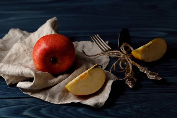 Ripe apple fruits and knife at old wooden table with canvas — Stock Photo, Image