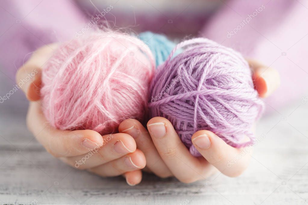 clew of wool in woman hands