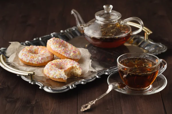 Tea for breakfast with fresh pastry donuts
