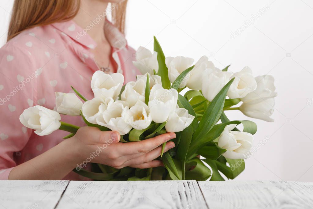 girl with a bouquet of tulips bestowed