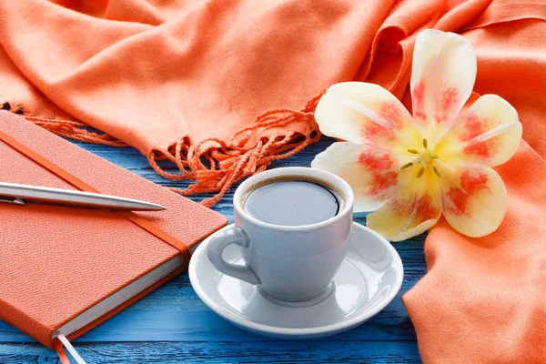 Cup of coffee on turquoise wooden table with open flower of tuli — Stock Photo, Image