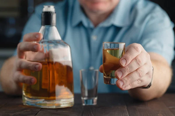man offering some shot of alcohol as a solution to your problems