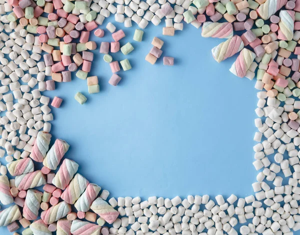 青の背景にカラフルなマシュマロ菓子フレーム — ストック写真