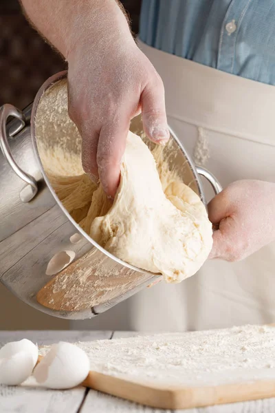 Close up view of baker kneading dough. Homemade bread. Hands pre