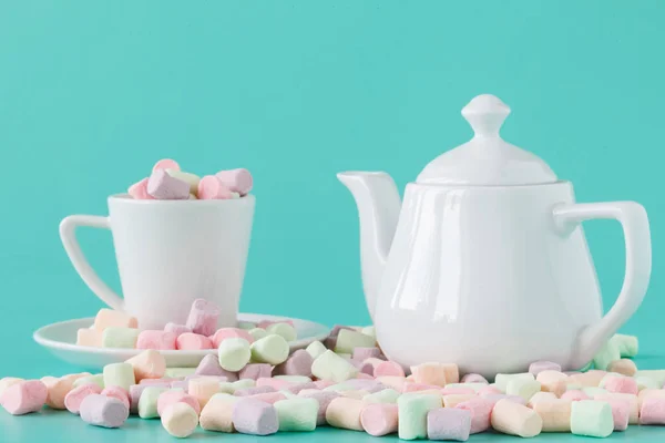 Marshmallow i en kopp på en akvamarin bakgrund. — Stockfoto