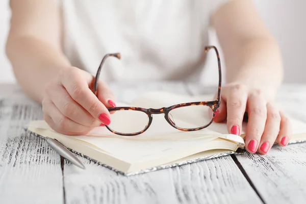 stock image Surprised businesswoman taking off glasses while reading in office