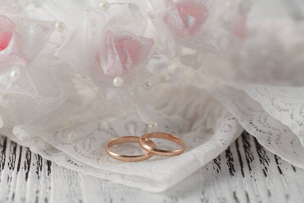 Wedding rings on white satin