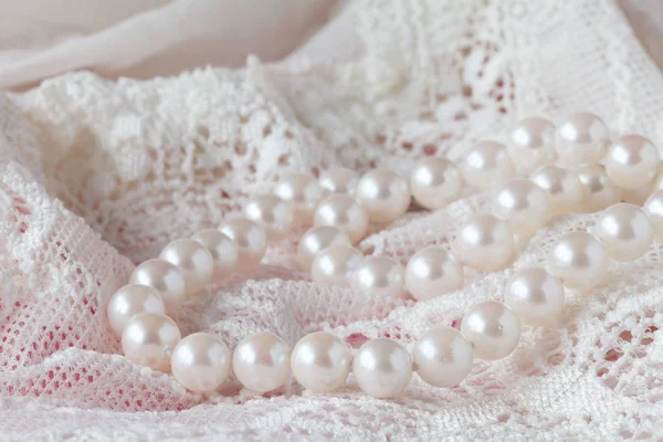Background of white delicate lace fabric and pearls — Stock Photo, Image