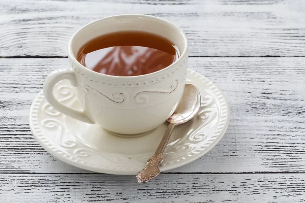 Hot tea in old cup — Stock Photo, Image