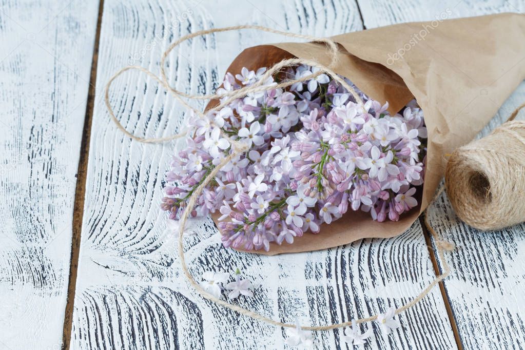 Lilac flowers on background of shabby wooden planks in rustic st