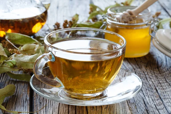 Cam Çaydanlık ve bardak yeşil çay üzerinde eski ahşap masa.