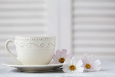 Beyaz kahve fincanı ve beyaz çiçekler yakın çekim bir buket