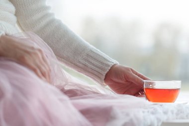 Sıcak bir fincan çay kadınla retro yün kazak eller