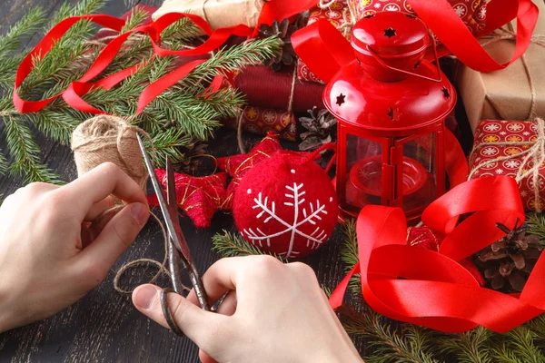 Creative hobby. hands wrap christmas holiday handmade present in craft paper with twine ribbon