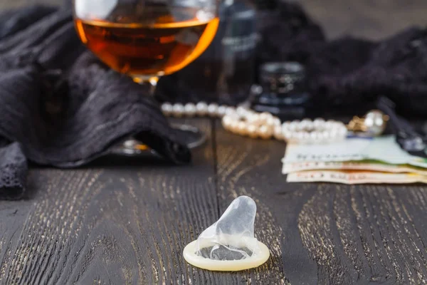 Underwear, cognac and money to symbolize the cost of sex — Stock Photo, Image