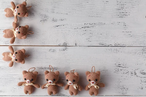 Toy knitted bear on white table