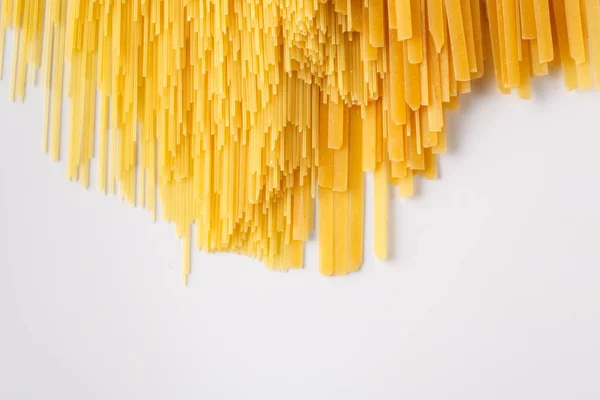 Photo of the yellow raw pasta background — Stock Photo, Image