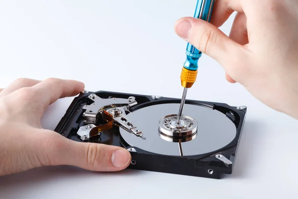 Used hard drive is opened, spindle is opening by a screw driver — Stock Photo, Image