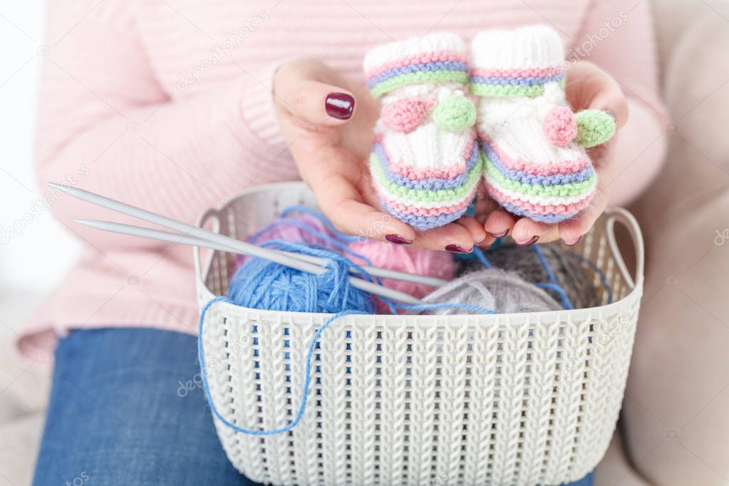 Close up view of female hand with color clew, knitting concept