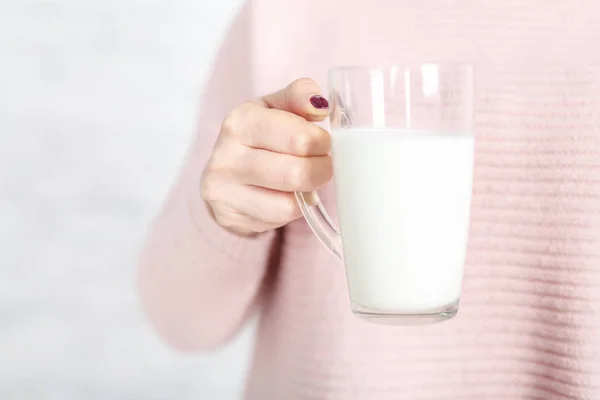 a woman gives you a cup of milk