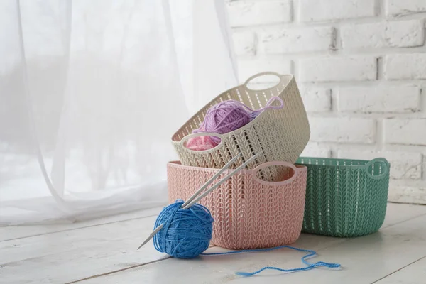 home organizers colored baskets on white table