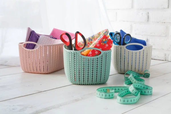 home organizers colored baskets on white table