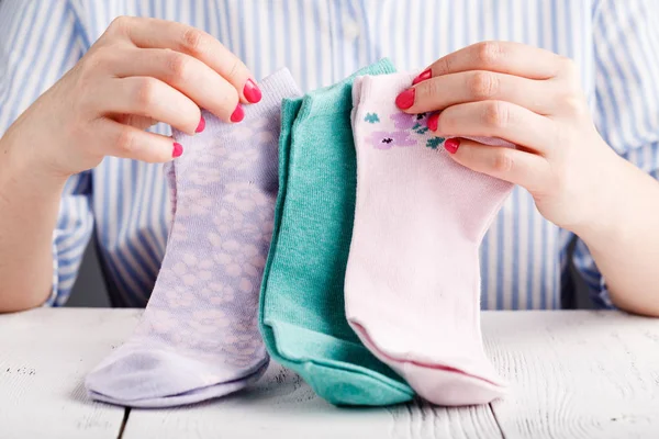 Female hold socks in hands — Stock Photo, Image