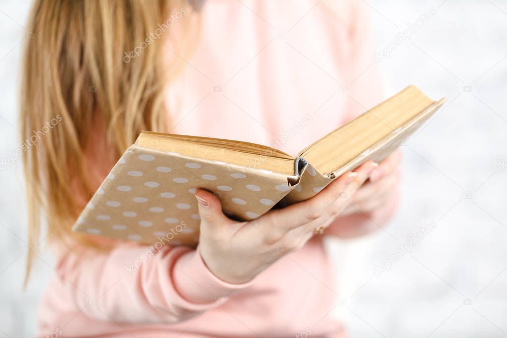 Female reading book, close up