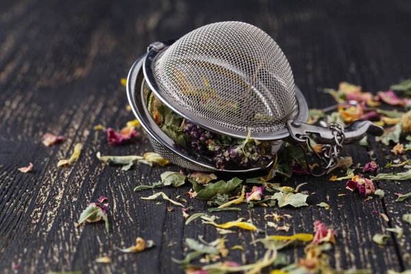 Heap of loose herbal tea on wooden table