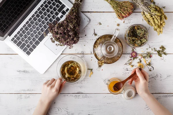 Δέσμη των φαρμακευτικών βοτάνων, φλιτζάνι τσάι υγιή και τσάντα από ξηρό υγιή μαργαρίτες σε ξύλινη σανίδα. Βοτανοθεραπεία. — Φωτογραφία Αρχείου