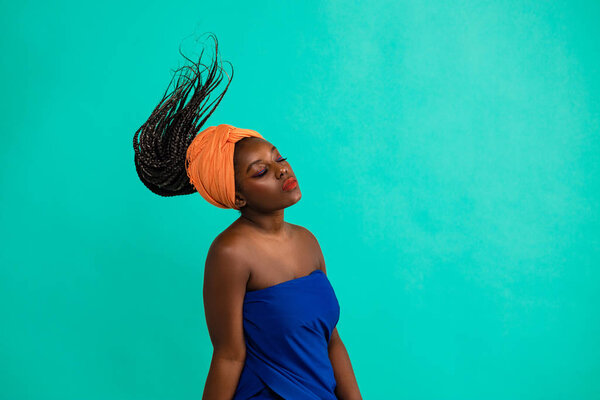 Beautiful girl with African roots on a blue background