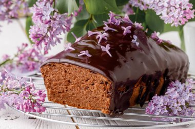 Beyaz arka planda çiçekli klasik çikolatalı pasta.
