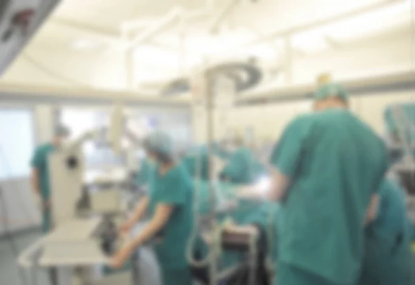 Surgical team operating on patient in theater in hospital blurred. — Stock Photo, Image