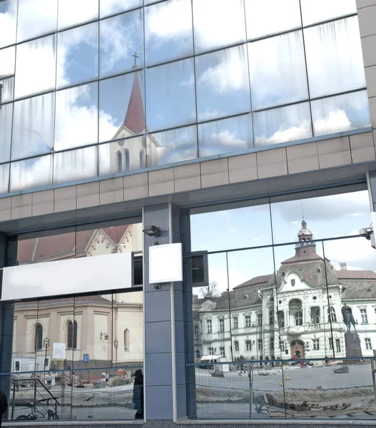 Reflection of stone facade on modern glass facade — Stock Photo, Image