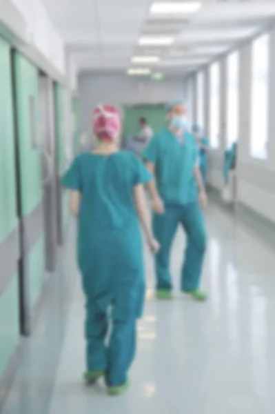 Doctors and nurses walking in hospital hallway, blurred motion. Stock Picture