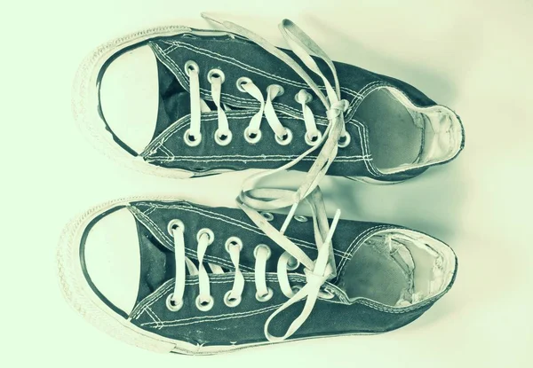 A pair of dirty sneakers on top retro textured background — Stock Photo, Image