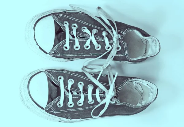 A pair of dirty sneakers on top retro textured background — Stock Photo, Image
