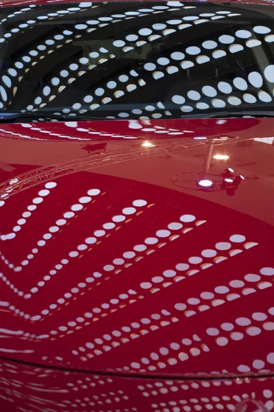 Reflection of building lights on car's hood — Stock Photo, Image