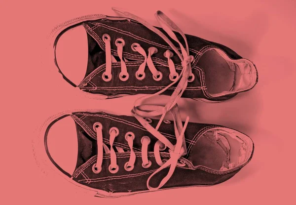 A pair of dirty sneakers on top retro background — Stock Photo, Image