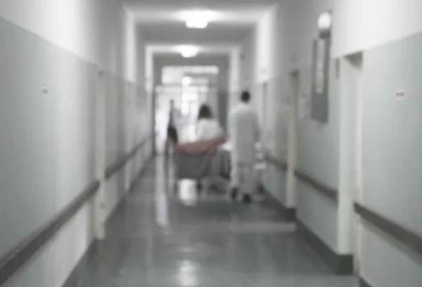 Doctors and nurses walking in hospital hallway, blurred motion. — Stock Photo, Image