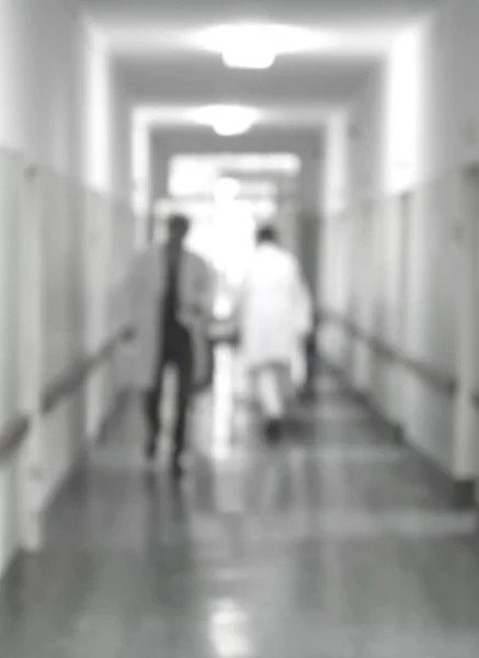 Doctors and nurses walking in hospital hallway, blurred motion. — Stock Photo, Image