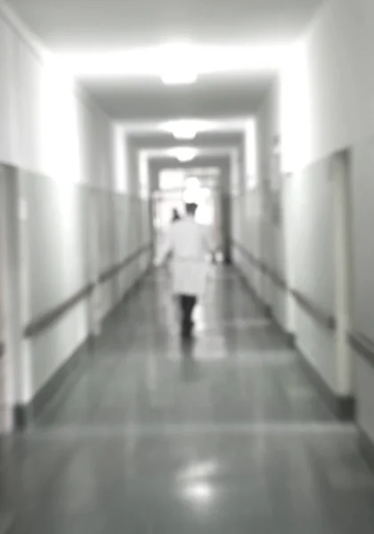 Doctors and nurses walking in hospital hallway, blurred motion. Royalty Free Stock Images